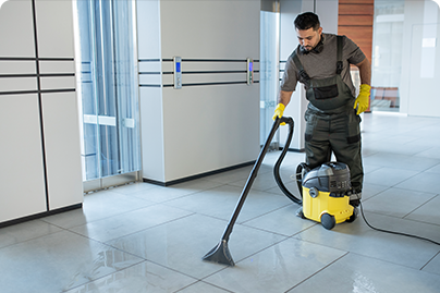 full shot man vacuuming office floor